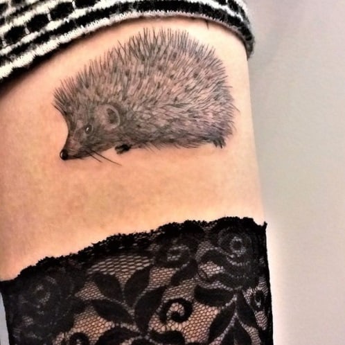 hedgehog on thigh black ink tattoo