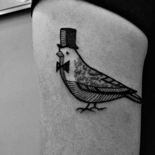 pigeon on bicep black ink tattoo