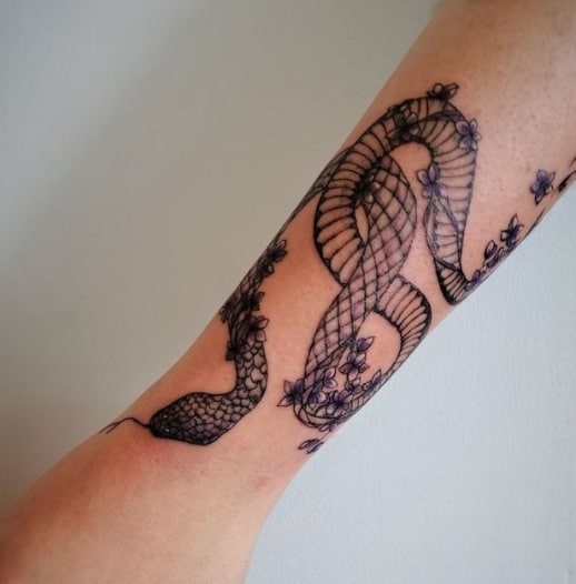 snake on forearm black ink tattoo