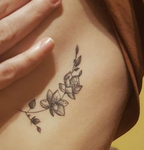 flowers tattoo on ribs for woman