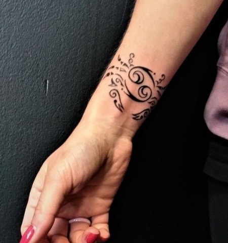 cancer zodiac sign tattoo on wrist