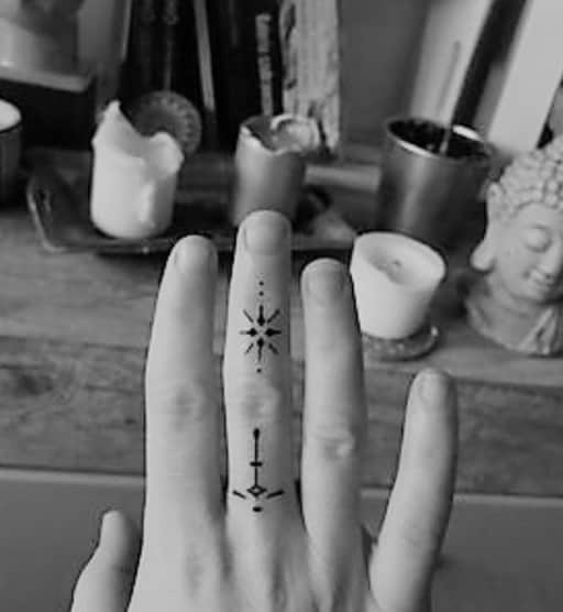 lines and dots tattoo on finger