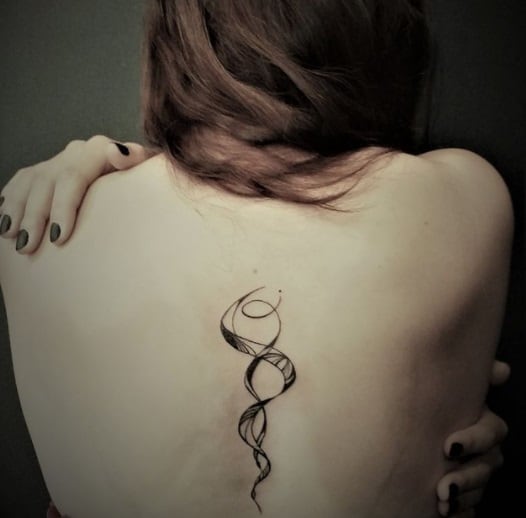 two snakes tattoo on the back for women 