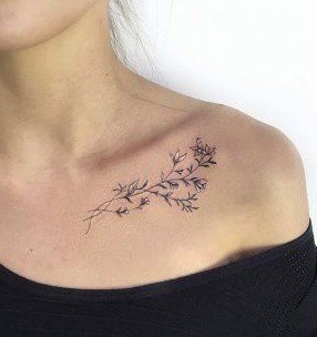 small tattoo on the collarbone