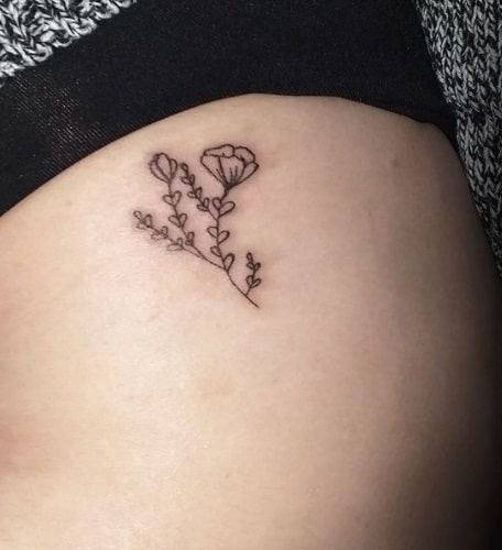 small flower tattoo on thigh for women